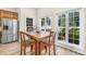 Cozy breakfast nook filled with natural light, wood table, and stainless steel refrigerator at 112 Berea Baptist Church Rd, Stanfield, NC 28163