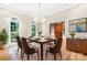 Dining room with a modern chandelier, sleek table, and large windows with natural light at 112 Berea Baptist Church Rd, Stanfield, NC 28163