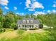 Beautiful two-story home featuring a well-manicured lawn, mature trees, and a welcoming front porch at 112 Berea Baptist Church Rd, Stanfield, NC 28163