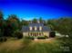 Inviting home featuring dormer windows, a manicured lawn, and flowering bushes for picturesque curb appeal at 112 Berea Baptist Church Rd, Stanfield, NC 28163