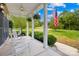 Inviting covered front porch with rocking chairs, ferns, and an American flag at 112 Berea Baptist Church Rd, Stanfield, NC 28163