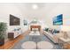 Inviting living room featuring hardwood floors, comfortable seating, a large screen television, and tasteful decor at 112 Berea Baptist Church Rd, Stanfield, NC 28163