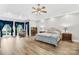 Bright main bedroom with hardwood floors, chair, and large windows providing natural light at 112 Berea Baptist Church Rd, Stanfield, NC 28163