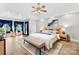 Spacious main bedroom features a tray ceiling, ceiling fan, hardwood floors and a seating area at 112 Berea Baptist Church Rd, Stanfield, NC 28163