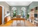 Well-lit home office featuring built-in shelving, arched windows, and modern decor at 112 Berea Baptist Church Rd, Stanfield, NC 28163