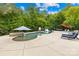 Resort-style pool area with a spa, lounge chairs, slide, and umbrella, ideal for outdoor living at 112 Berea Baptist Church Rd, Stanfield, NC 28163