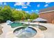 Backyard pool area with a spa, slide, and seating, perfect for relaxation and entertainment at 112 Berea Baptist Church Rd, Stanfield, NC 28163