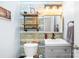 Stylish powder room featuring unique wallpaper, industrial shelving, and a modern vanity with pendant lighting at 112 Berea Baptist Church Rd, Stanfield, NC 28163