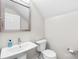 Clean powder room with a pedestal sink, framed mirror, and modern toilet at 112 Berea Baptist Church Rd, Stanfield, NC 28163