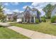 Two-story home with front porch and landscaped yard at 1180 Weir Ct, Fort Mill, SC 29708