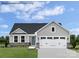 Charming single-Gathering home featuring stone accents, a two-car garage, and a well-manicured lawn at 467 Hollis Dr # 0055, Lancaster, SC 29720