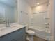 Clean bathroom with gray vanity, white tub, and tile floor at 210 Alden Ct, Shelby, NC 28152