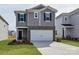 Two-story house with gray siding, brick accents, and a two-car garage at 210 Alden Ct, Shelby, NC 28152