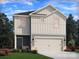 Two-story house with gray siding, white garage door, and landscaping at 210 Alden Ct, Shelby, NC 28152