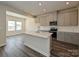 Modern kitchen with gray cabinets, granite countertops, and an island at 210 Alden Ct, Shelby, NC 28152