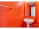 Vibrant orange bathroom featuring a modern sink and mirror at 4242 Quinn Dr, Charlotte, NC 28269