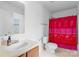 Bright bathroom featuring a vanity sink and toilet with a vibrant shower curtain at 4242 Quinn Dr, Charlotte, NC 28269