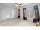 Spacious bedroom with neutral carpet, ceiling fan, and large windows at 4242 Quinn Dr, Charlotte, NC 28269