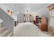 Bright living room featuring neutral carpet, a staircase, and ample space at 4242 Quinn Dr, Charlotte, NC 28269