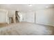 Unfinished basement space featuring neutral carpet, a staircase, and doors leading to other areas of the home at 2008 Embassy Ct # 45, Charlotte, NC 28213
