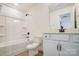 Bathroom features a tub-shower, wood-look floors, and a white vanity at 2008 Embassy Ct # 45, Charlotte, NC 28213