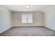 Bright, carpeted bedroom with neutral walls and a window at 2008 Embassy Ct # 45, Charlotte, NC 28213