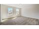 Well-lit bedroom featuring two windows and neutral carpeting, creating a comfortable and inviting space at 2008 Embassy Ct # 45, Charlotte, NC 28213