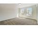 Bright bedroom with large windows, plush carpeting, and plenty of natural light for a peaceful retreat at 2008 Embassy Ct # 45, Charlotte, NC 28213