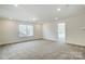 Bonus room featuring neutral carpet, a window providing natural light, and minimalist decor at 2008 Embassy Ct # 45, Charlotte, NC 28213