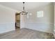 Open dining area with large windows, stylish lighting, and an adjacent kitchen at 2008 Embassy Ct # 45, Charlotte, NC 28213