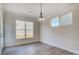 Bright dining room with large windows, modern light fixture, and neutral walls and flooring at 2008 Embassy Ct # 45, Charlotte, NC 28213