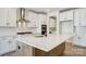 Well-lit kitchen features stainless steel appliances, a spacious island with a sink, and modern white cabinetry at 2008 Embassy Ct # 45, Charlotte, NC 28213