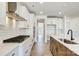 Spacious kitchen features stainless steel appliances, tile backsplash, and an island with a sink and modern fixtures at 2008 Embassy Ct # 45, Charlotte, NC 28213
