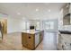 Open floor plan showcasing a kitchen island, stainless steel appliances, and a view into the living room at 2008 Embassy Ct # 45, Charlotte, NC 28213