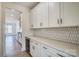 Bright, modern kitchen with a wine cooler, white cabinetry, and tiled backsplash at 2008 Embassy Ct # 45, Charlotte, NC 28213