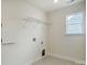 Bright laundry room with wire shelving, utility connections, and a window at 2008 Embassy Ct # 45, Charlotte, NC 28213