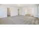 Open living room with neutral carpeting, white walls and multiple entryways, perfect for entertaining at 2008 Embassy Ct # 45, Charlotte, NC 28213