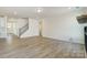Spacious living area featuring wood-look floors, fireplace, and an open layout at 2008 Embassy Ct # 45, Charlotte, NC 28213