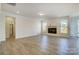 Open-concept living room with a cozy fireplace and ample natural light at 2008 Embassy Ct # 45, Charlotte, NC 28213