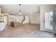 Open-concept floor plan with a kitchen island, living area, and staircase leading to the second floor at 2008 Embassy Ct # 45, Charlotte, NC 28213
