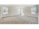 Spacious main bedroom filled with natural light from three windows and neutral colored carpet at 2008 Embassy Ct # 45, Charlotte, NC 28213
