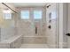 Luxurious tiled shower with a built-in bench and dual showerheads for a spa-like experience at 2008 Embassy Ct # 45, Charlotte, NC 28213