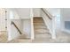 Carpeted staircase with white risers and stained handrail at 2008 Embassy Ct # 45, Charlotte, NC 28213