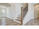 Elegant staircase with wood treads, dark metal railings, and a bright, open design at 2008 Embassy Ct # 45, Charlotte, NC 28213