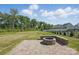 The backyard features a beautiful green lawn and a stone fire pit at 3253 Mcharney Dr # 27, Harrisburg, NC 28075