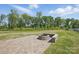 The backyard features a beautiful green lawn and a stone fire pit at 3253 Mcharney Dr # 27, Harrisburg, NC 28075