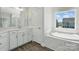 Stylish bathroom boasts a soaking tub, tiled walls, and sleek fixtures offering a spa-like experience at 3253 Mcharney Dr # 27, Harrisburg, NC 28075