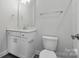 Bathroom featuring a white vanity, sink, toilet, and chrome fixtures at 3253 Mcharney Dr # 27, Harrisburg, NC 28075