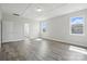 Bright bedroom features wood-look floors, two windows, a coffered ceiling, and ensuite bathroom access at 3253 Mcharney Dr # 27, Harrisburg, NC 28075
