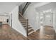 Welcoming entryway with hardwood floors, a staircase with wrought iron spindles, and ample natural light at 3253 Mcharney Dr # 27, Harrisburg, NC 28075